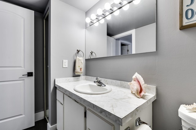 bathroom with toilet and vanity