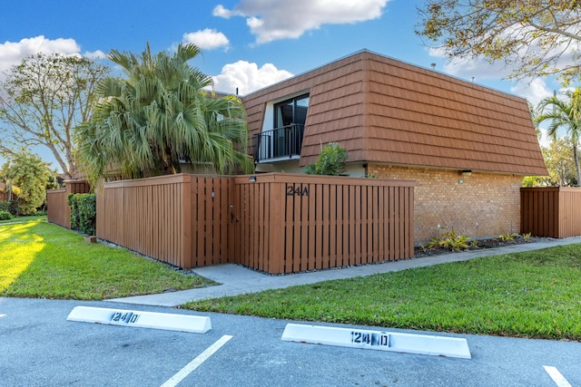 view of side of home with a yard