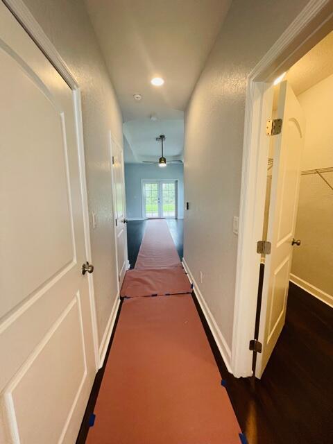 hall with dark wood-type flooring