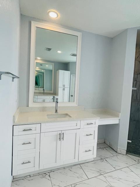 bathroom featuring vanity and walk in shower