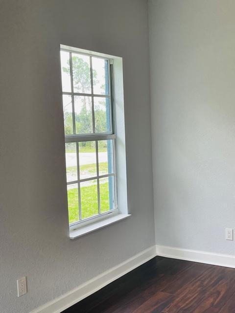 spare room featuring dark hardwood / wood-style floors