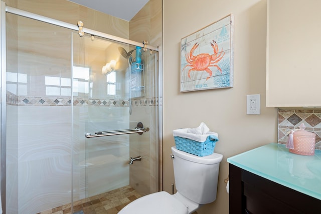 bathroom featuring walk in shower, vanity, and toilet