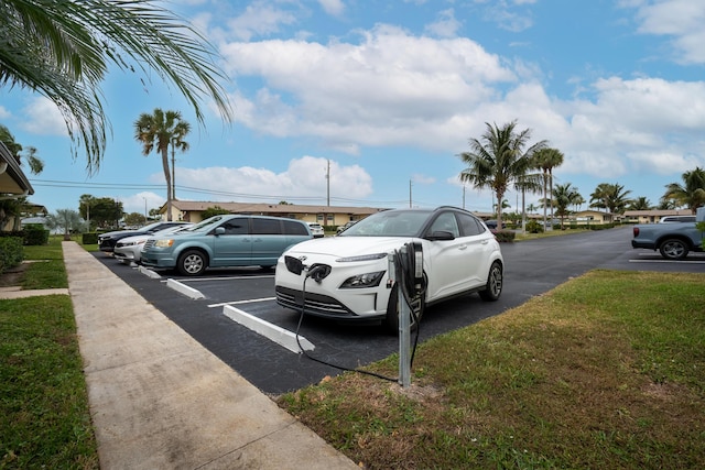 view of parking featuring a lawn