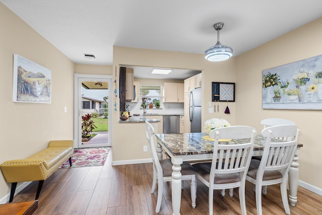 dining room with hardwood / wood-style flooring and sink