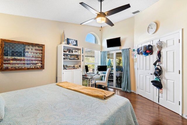 bedroom with access to exterior, dark hardwood / wood-style flooring, a textured ceiling, and ceiling fan