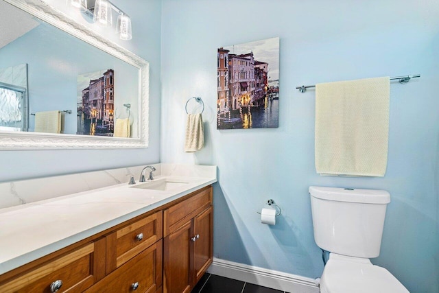 bathroom with tile patterned flooring, vanity, and toilet