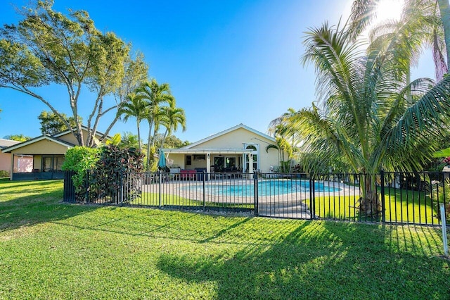 view of swimming pool featuring a lawn and a patio area