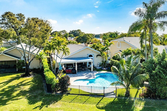 view of swimming pool featuring a lawn and a patio