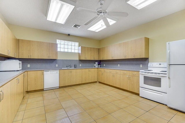 kitchen featuring light brown cabinetry, white appliances, ceiling fan, and sink