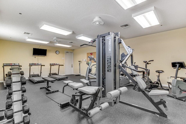 workout area featuring a textured ceiling