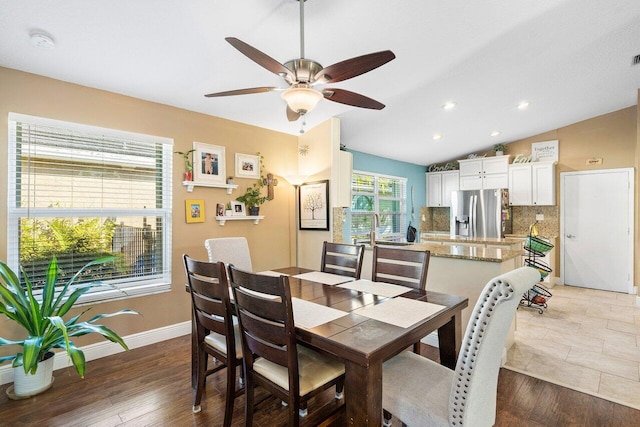 dining room featuring dark hardwood / wood-style flooring, ceiling fan, and lofted ceiling