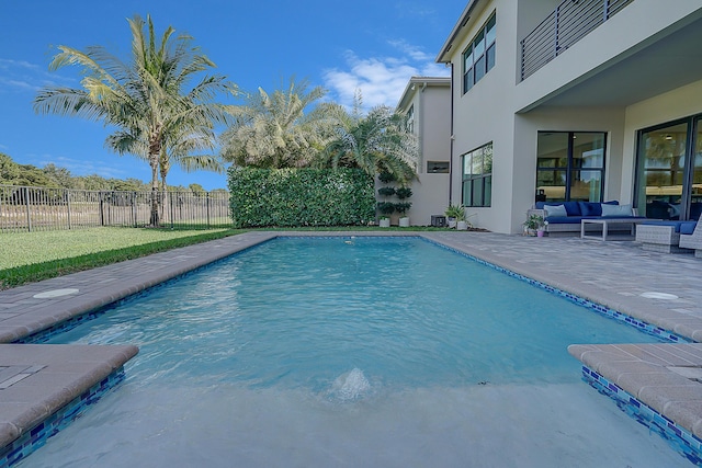 view of pool featuring outdoor lounge area and a patio