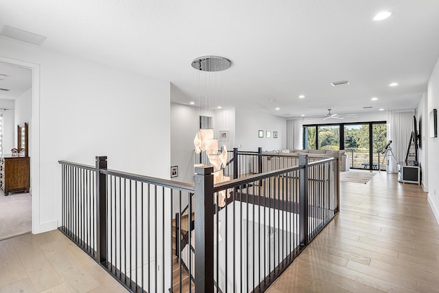 corridor with light hardwood / wood-style floors