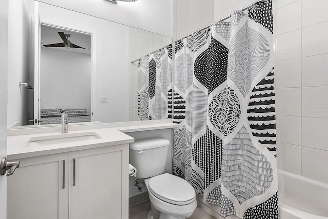 full bathroom with shower / bath combo with shower curtain, vanity, and toilet