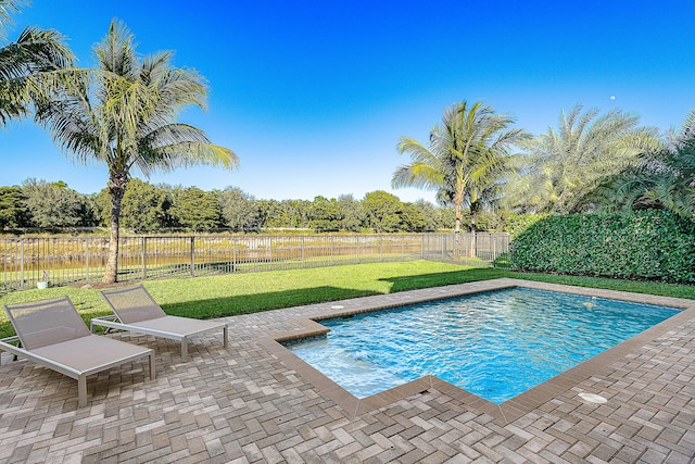 view of swimming pool with a patio area and a lawn