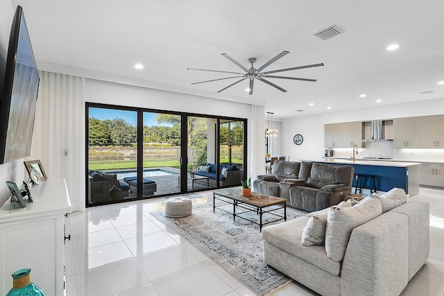 living room featuring ceiling fan, light tile patterned flooring, and sink