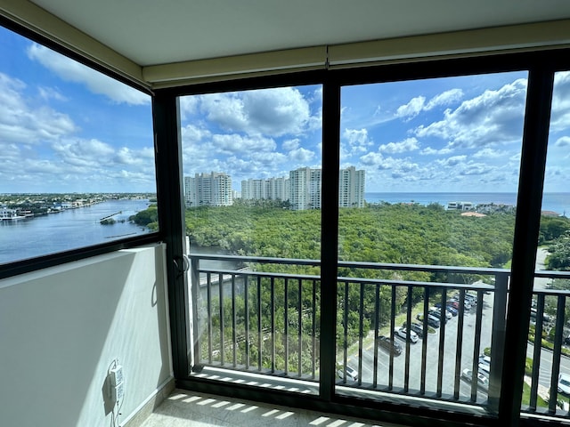 unfurnished sunroom featuring a water view