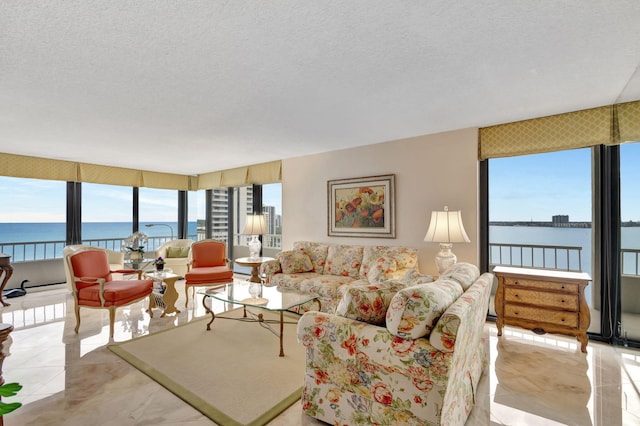 living room featuring a wealth of natural light, a textured ceiling, and a water view