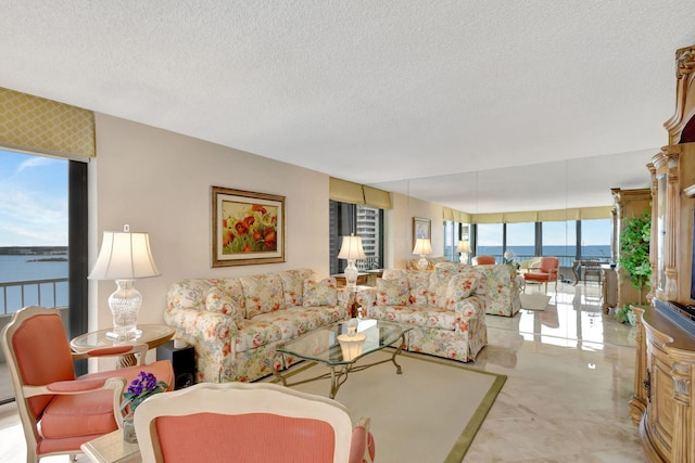 living room with a textured ceiling and a water view