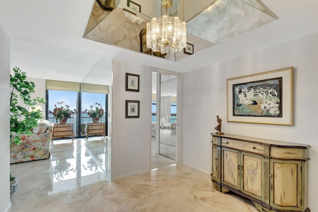 corridor with a notable chandelier and floor to ceiling windows