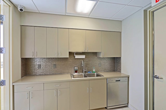 kitchen with tasteful backsplash, a paneled ceiling, dishwasher, and sink