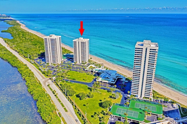 bird's eye view featuring a water view and a beach view