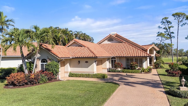 mediterranean / spanish house featuring a front yard