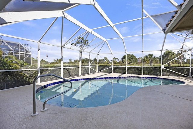 view of swimming pool with a lanai and a patio