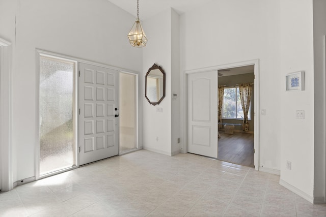 tiled entryway featuring a high ceiling