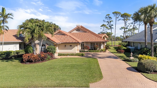 mediterranean / spanish-style home with a front lawn