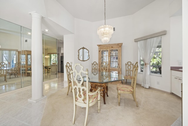 tiled dining room with decorative columns and an inviting chandelier