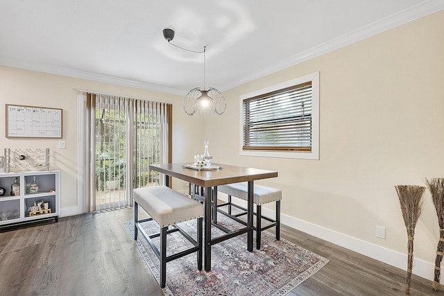 dining room featuring crown molding and dark hardwood / wood-style flooring