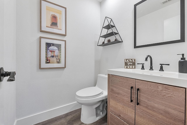 bathroom featuring hardwood / wood-style floors, vanity, and toilet