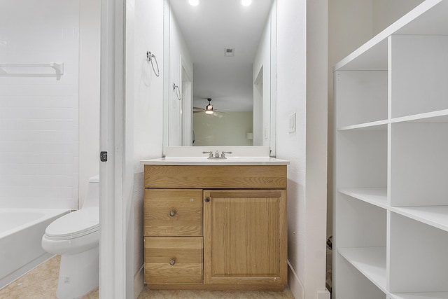 bathroom featuring ceiling fan, toilet, and vanity