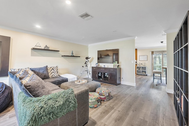 living room with hardwood / wood-style floors and crown molding