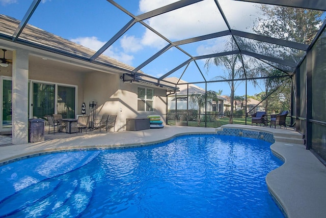 view of pool featuring a patio area and glass enclosure