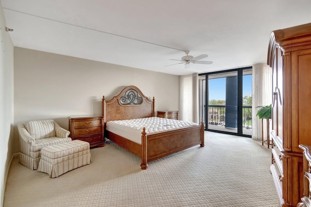 carpeted bedroom featuring ceiling fan, expansive windows, and access to exterior