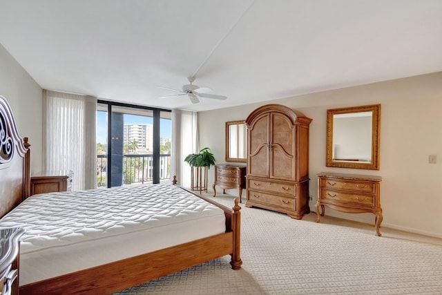 bedroom featuring ceiling fan, expansive windows, access to outside, and light carpet