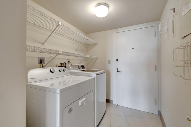 laundry area featuring light tile patterned floors and washer and dryer