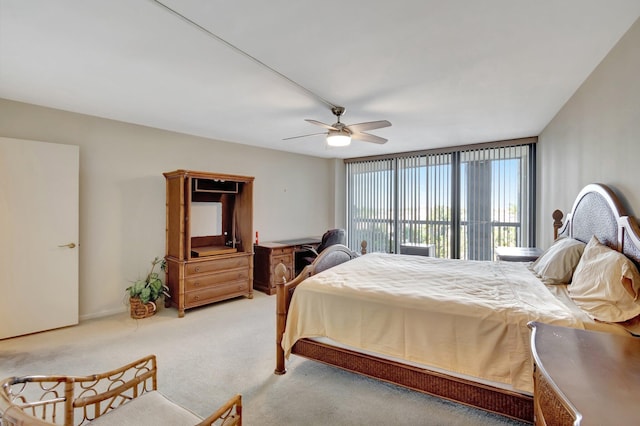 bedroom with ceiling fan, carpet, and floor to ceiling windows