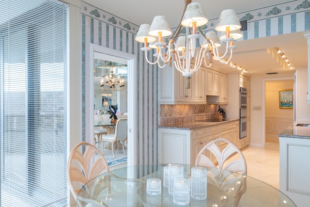 dining area with an inviting chandelier