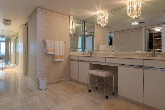 bathroom with a chandelier and vanity