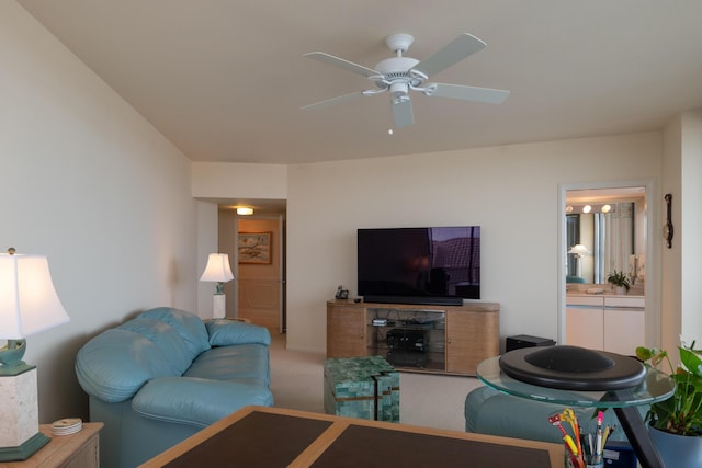 carpeted living room with ceiling fan