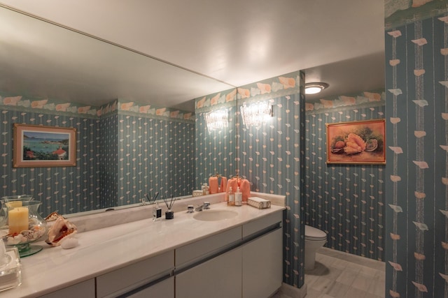 bathroom featuring toilet and vanity