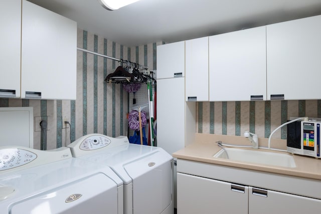 laundry room with separate washer and dryer, cabinets, and sink