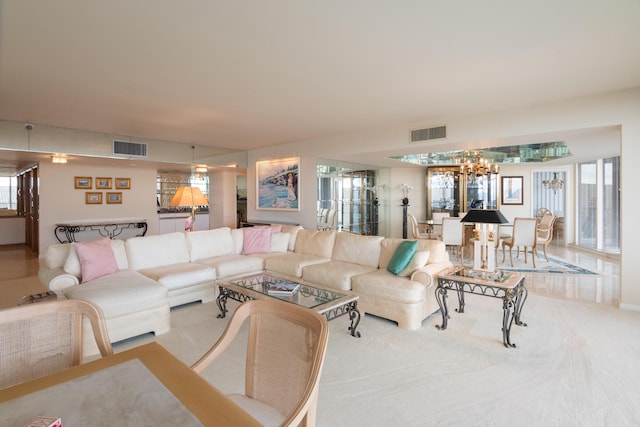 living room featuring an inviting chandelier and light carpet