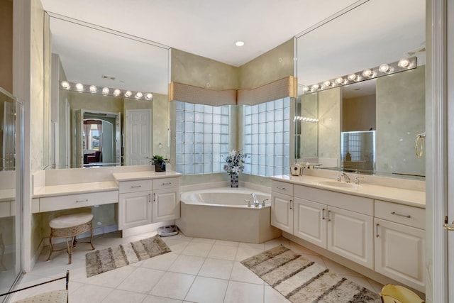 full bath with tile patterned flooring, a bath, and vanity