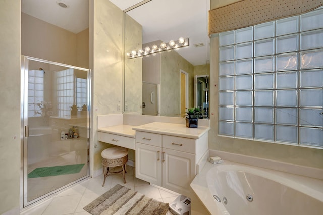 bathroom with a stall shower, tile patterned flooring, a tub with jets, and vanity