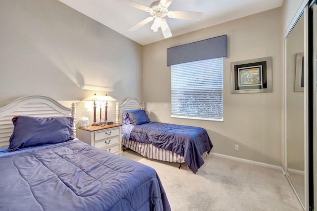 bedroom with light carpet, ceiling fan, and baseboards