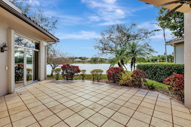 view of patio / terrace with a water view and ceiling fan